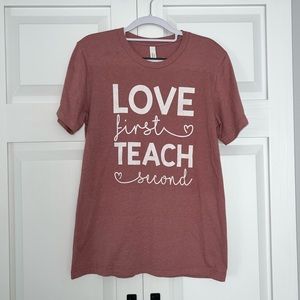 Pink teacher t-shirt.